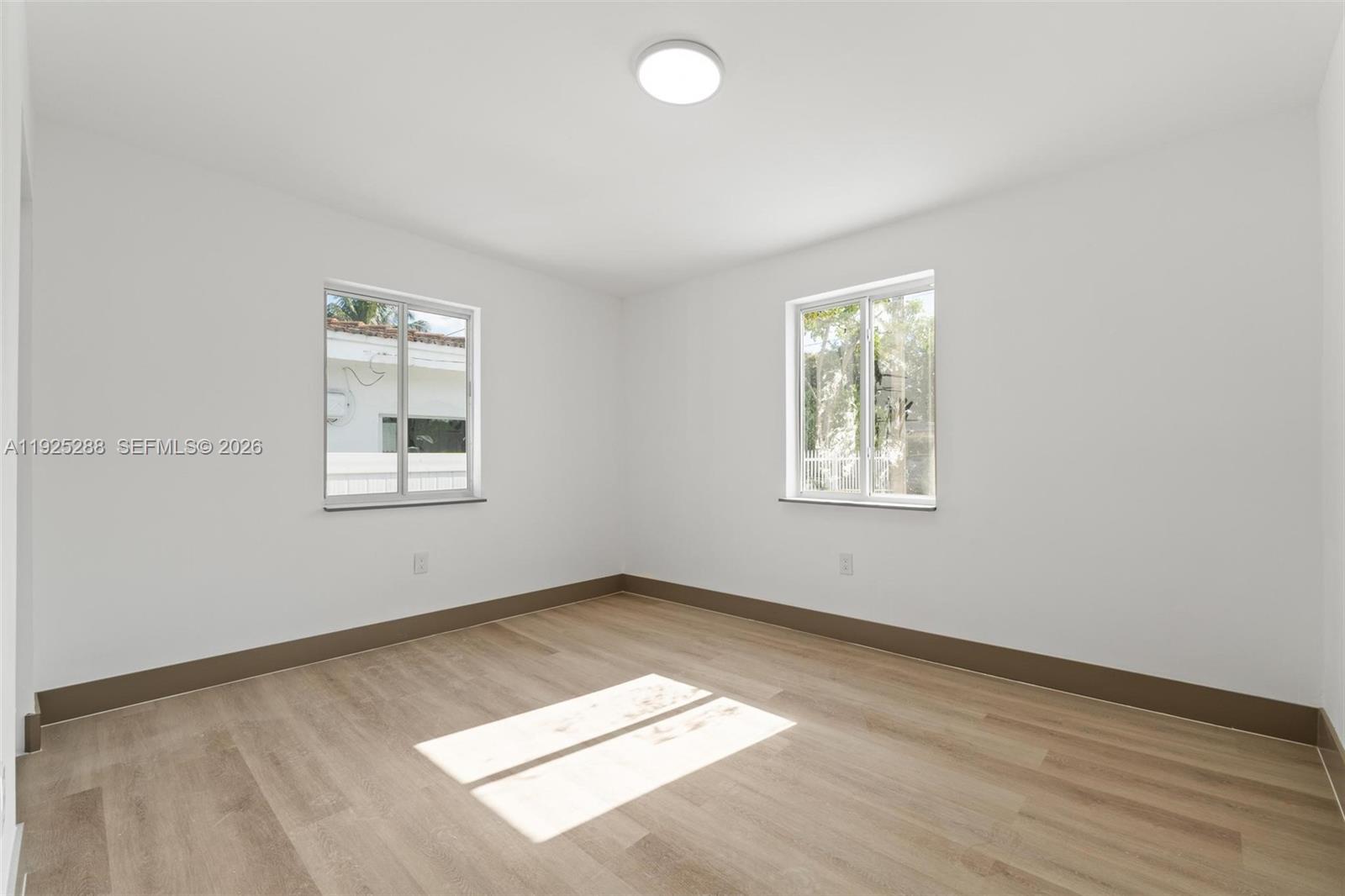 1453 Northwest 56th Street Miami, FL 33142 - Photo 21 of 29 an empty room with windows