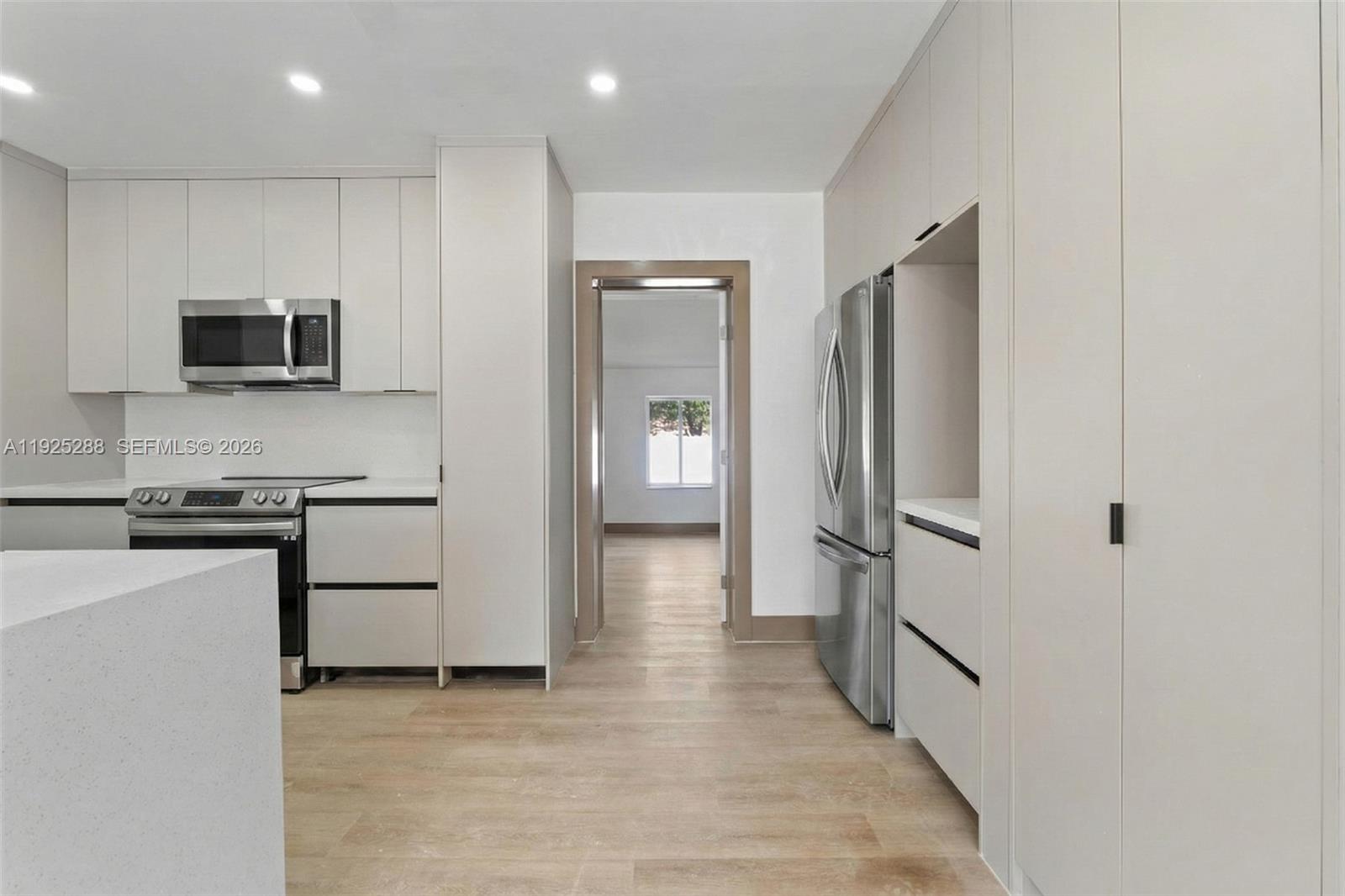 1453 Northwest 56th Street Miami, FL 33142 - Photo 3 of 29 a kitchen with stainless steel appliances a refrigerator stove and microwave