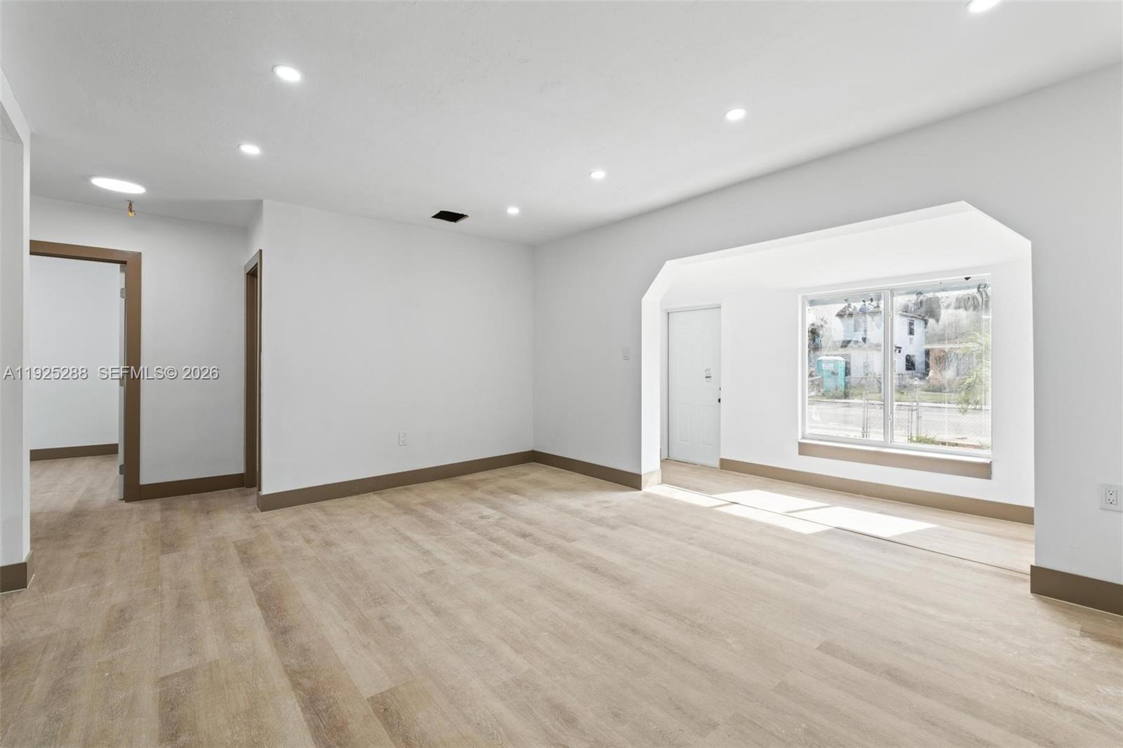 1453 Northwest 56th Street Miami, FL 33142 - Photo 7 of 29 a view of an empty room with a window