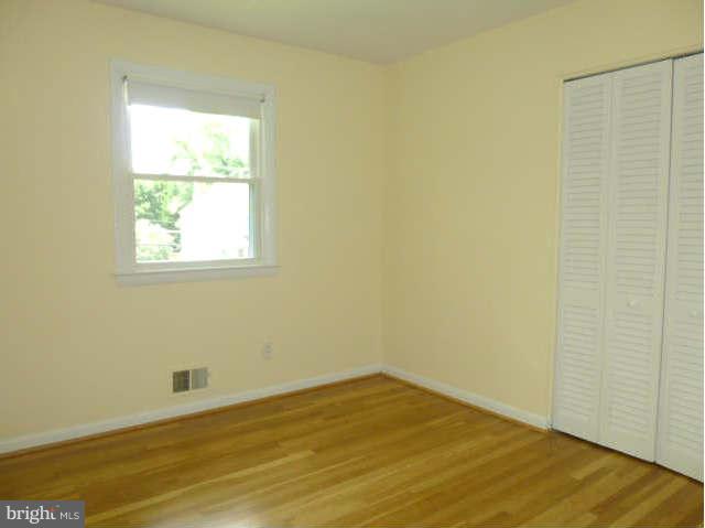 2225 Forest Glen Road Silver Spring, MD 20910 - Photo 12 of 30 an empty room with wooden floor and a window