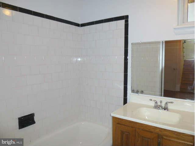 2225 Forest Glen Road Silver Spring, MD 20910 - Photo 18 of 30 a bathroom with a sink and a mirror