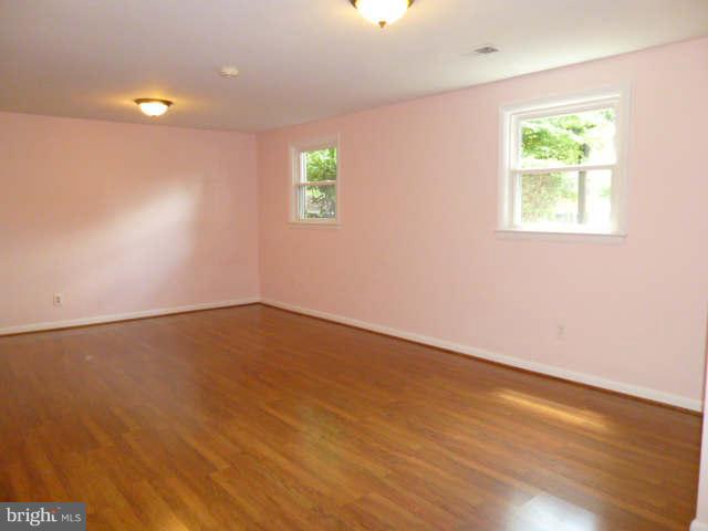 2225 Forest Glen Road Silver Spring, MD 20910 - Photo 21 of 30 an empty room with wooden floor and windows