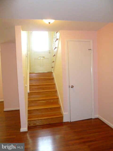 2225 Forest Glen Road Silver Spring, MD 20910 - Photo 22 of 30 a view of a hallway with wooden floor and a bathroom