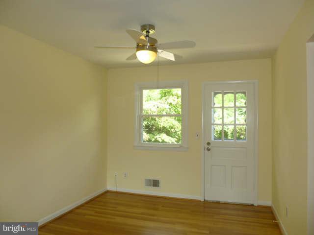 2225 Forest Glen Road Silver Spring, MD 20910 - Photo 6 of 30 a view of an empty room with wooden floor and a window