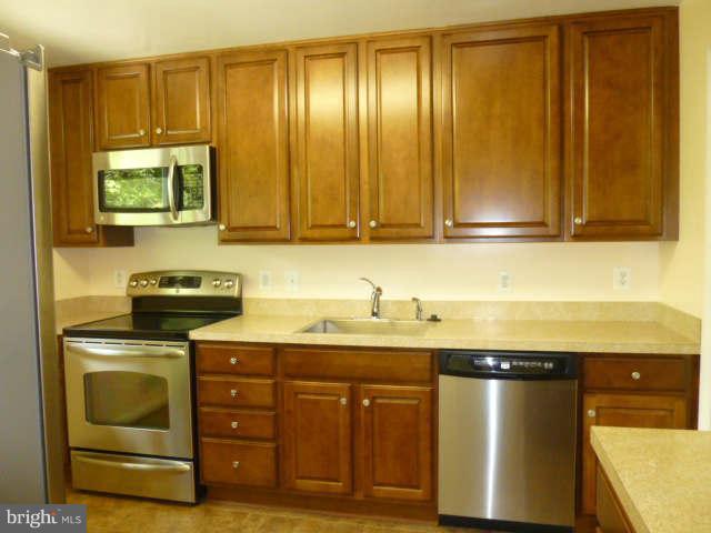 2225 Forest Glen Road Silver Spring, MD 20910 - Photo 8 of 30 a kitchen with granite countertop a sink a stove and cabinets