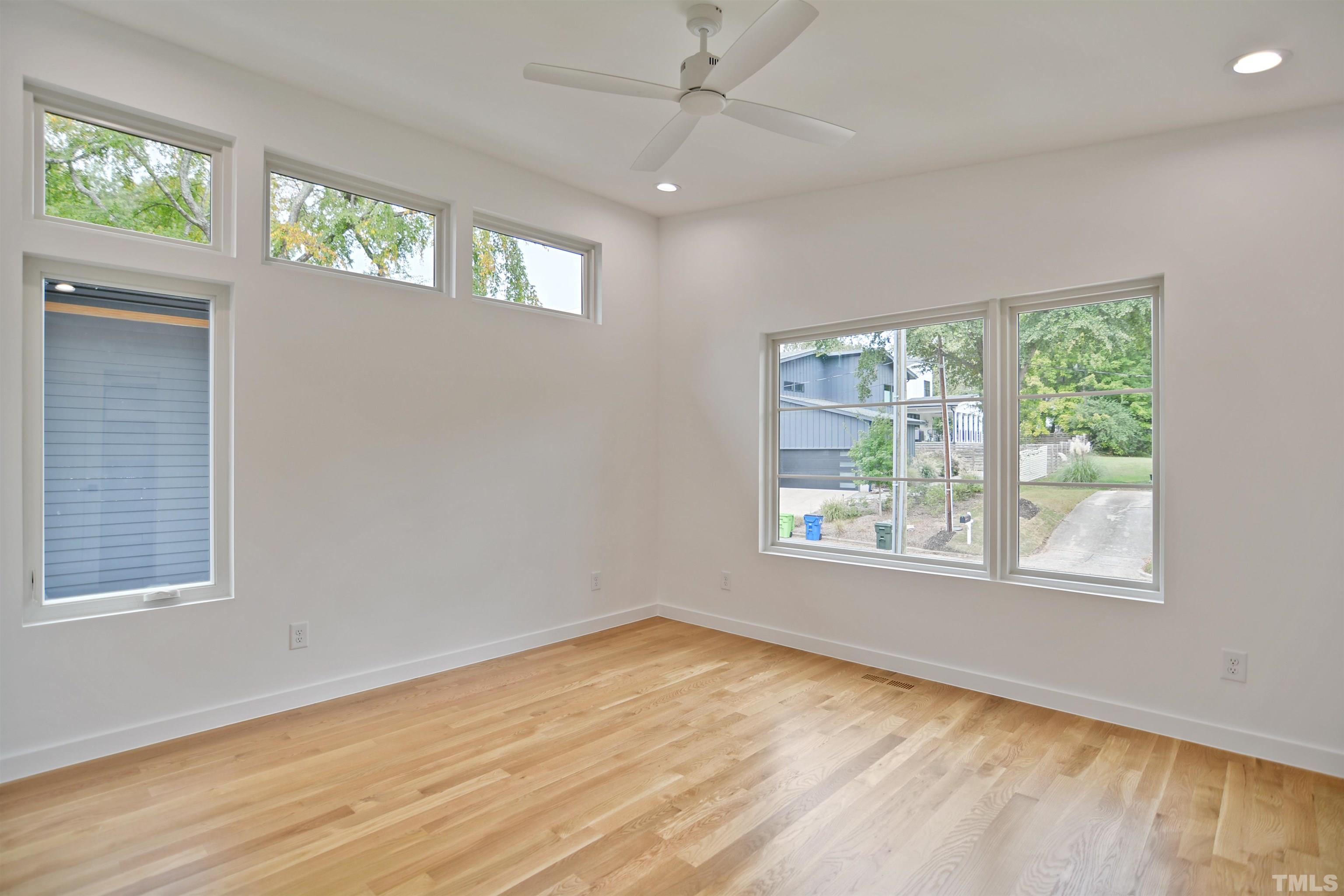 1306 East Lenoir Street Raleigh, NC 27610 - Photo 13 of 26 a view of an empty room with a window and wooden floor