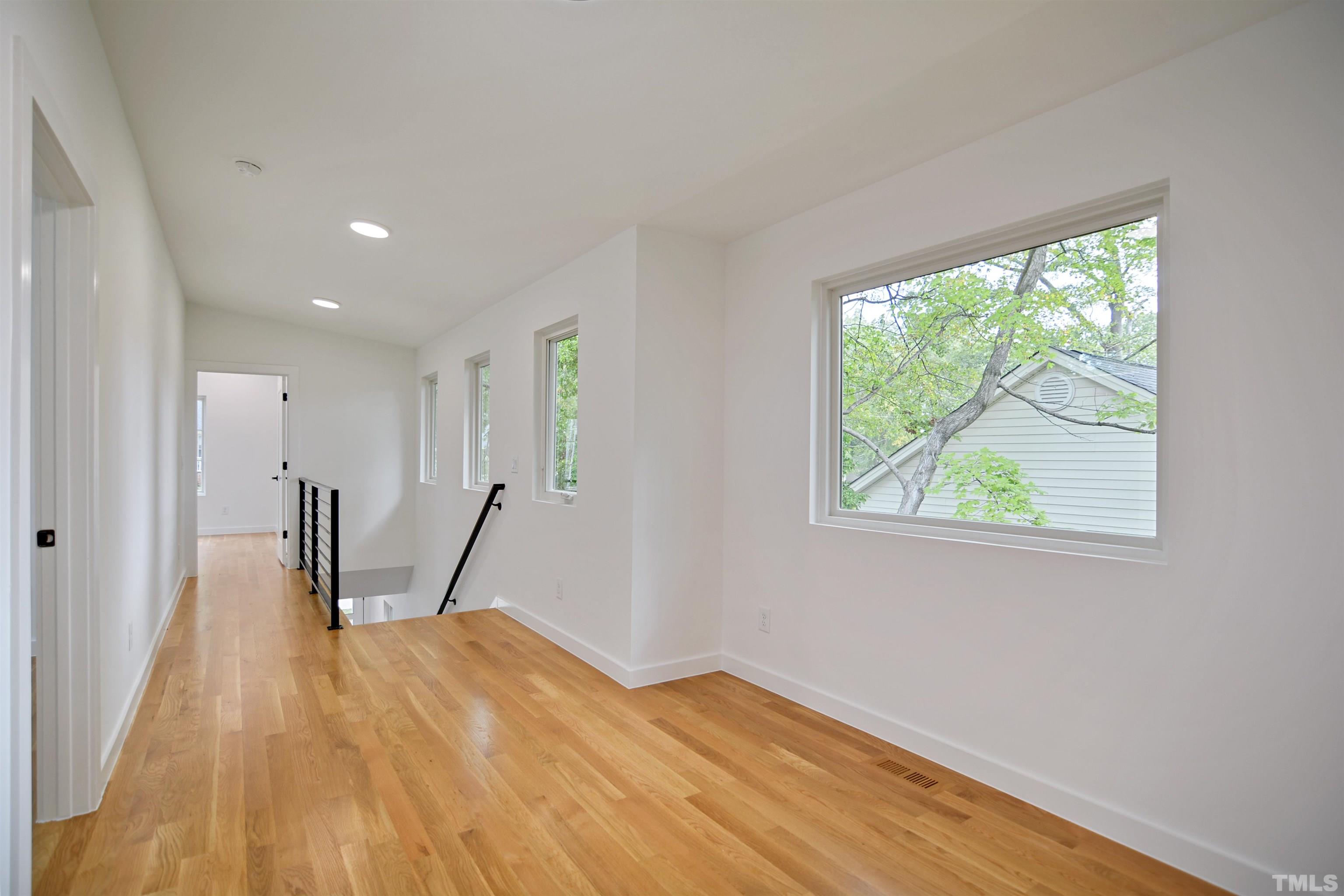 1306 East Lenoir Street Raleigh, NC 27610 - Photo 19 of 26 a view of empty room with wooden floor and window