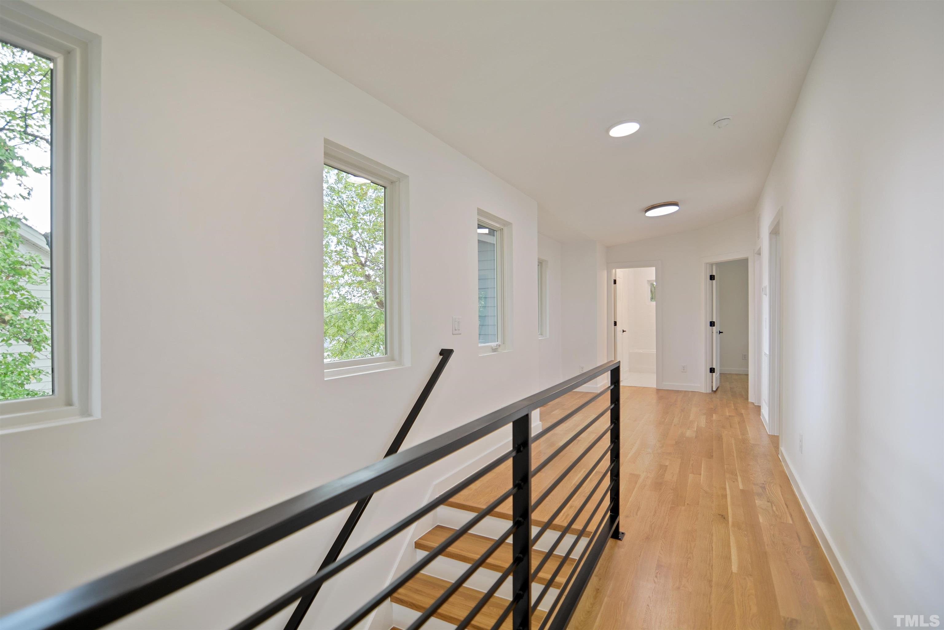 1306 East Lenoir Street Raleigh, NC 27610 - Photo 20 of 26 a view of a hallway with wooden floor and stairs