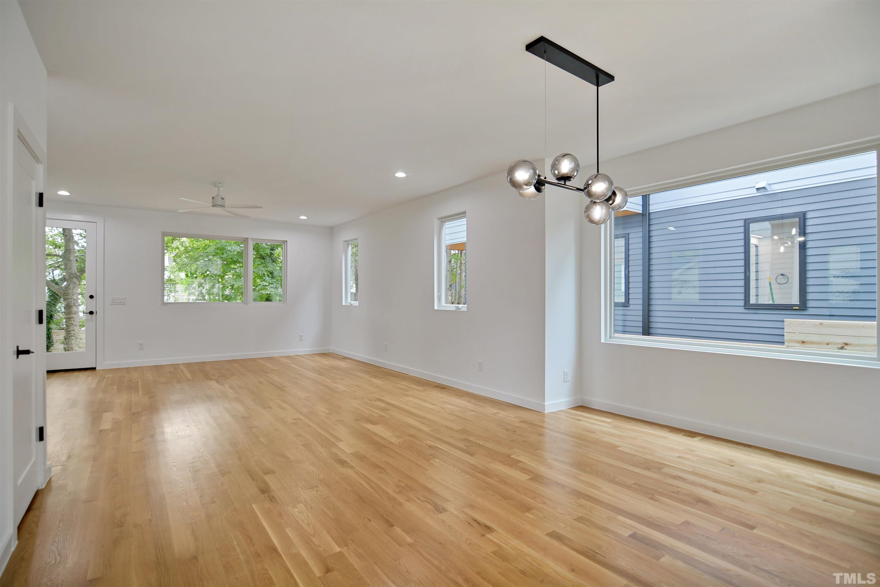 1306 East Lenoir Street Raleigh, NC 27610 - Photo 7 of 26 a view of an empty room with window and wooden floor