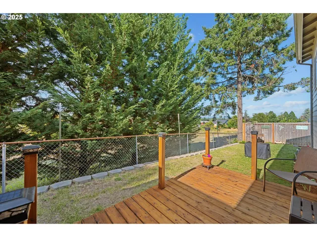 a view of a deck with chair and wooden floor