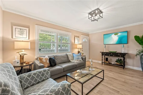 a living room with furniture a large window and a flat screen tv