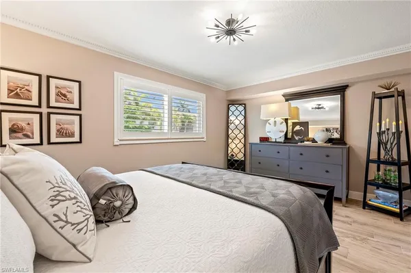 a spacious bedroom with a bed dresser and a window