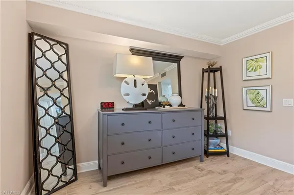 a room with a dresser and a window