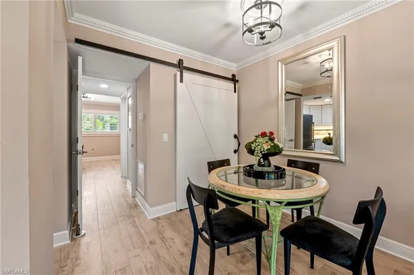 a dining room with furniture and wooden floor