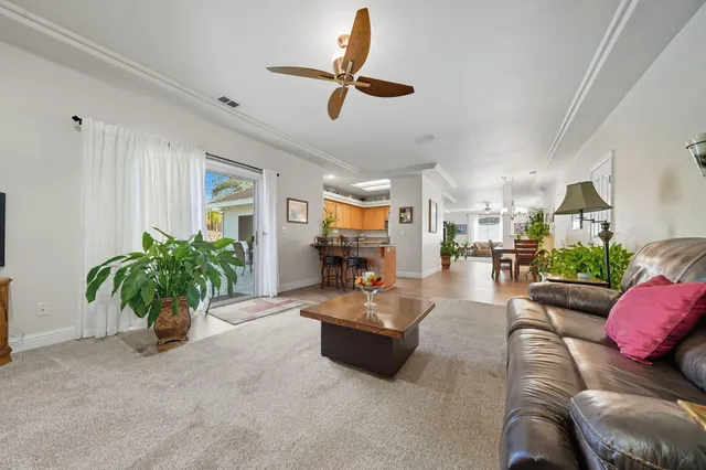 a living room with furniture flowers and a chandelier