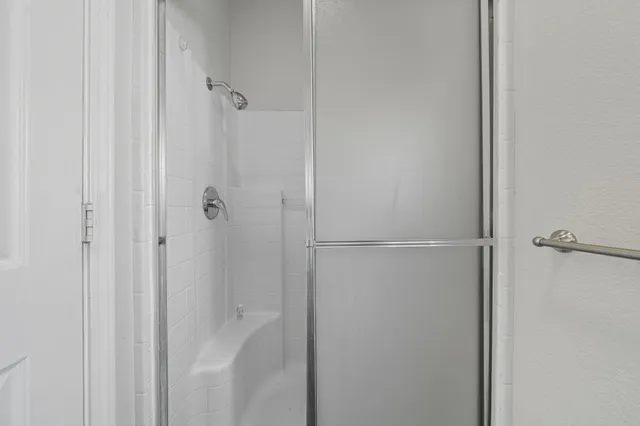 a bathroom with a glass shower door