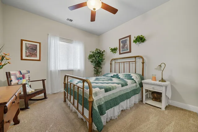a bedroom with furniture and a chandelier