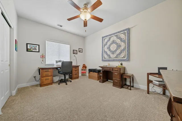 a living room with furniture and a piano