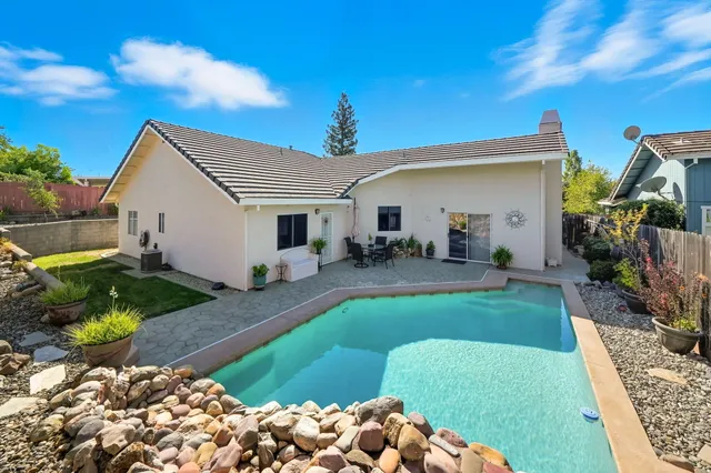a view of swimming pool with chairs