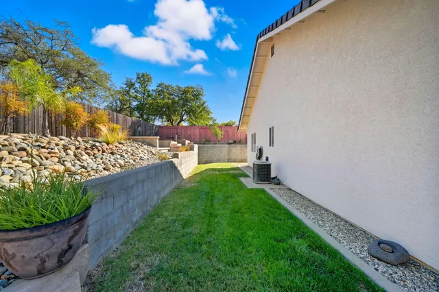 a view of a patio with table and chairs with wooden floor and fence