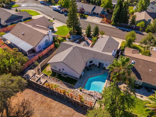 an aerial view of a city with lots of residential buildings and ocean view