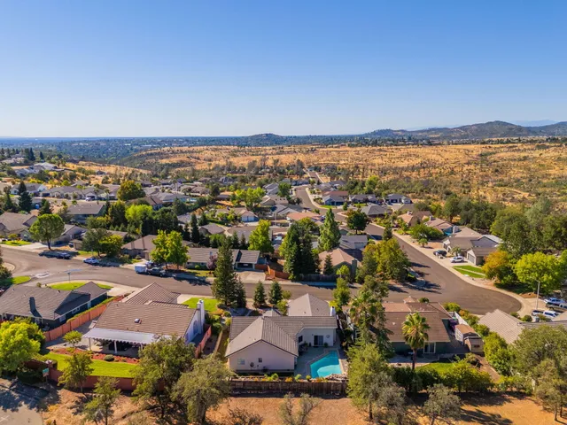 an aerial view of houses with yard