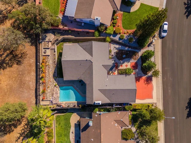 an aerial view of a house with a yard and a garage