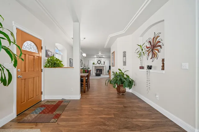 a view of a hallway to a livingroom with furniture