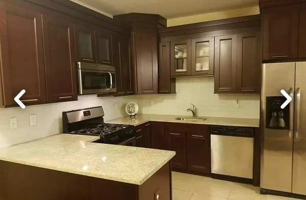 a kitchen with a sink a stove and refrigerator