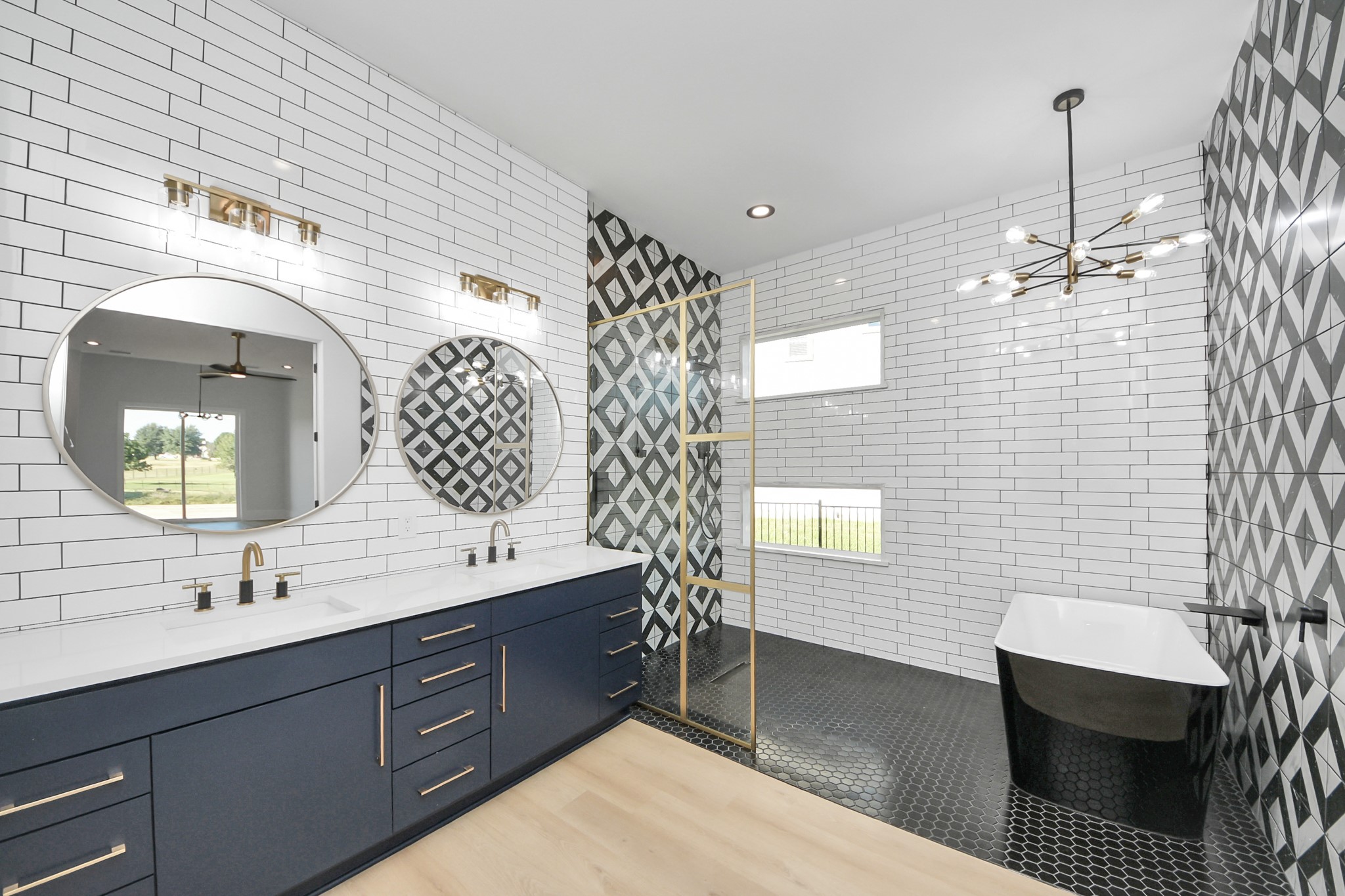 299 Peninsula Point Drive Montgomery, TX 77356 - Photo 24 of 50 A spa-inspired primary en suite featuring a double quartz vanity with custom cabinetry, designer lighting, a frameless walk-in shower with bold geometric tile, and a freestanding soaking tub for a true resort-style retreat.