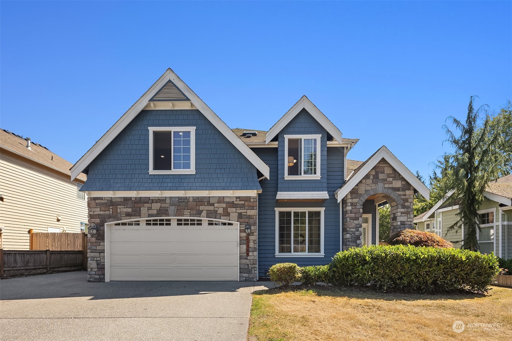 21104 39th Avenue Southeast Bothell, WA 98021 - Photo 1 of 36 a front view of a house with a yard and garage
