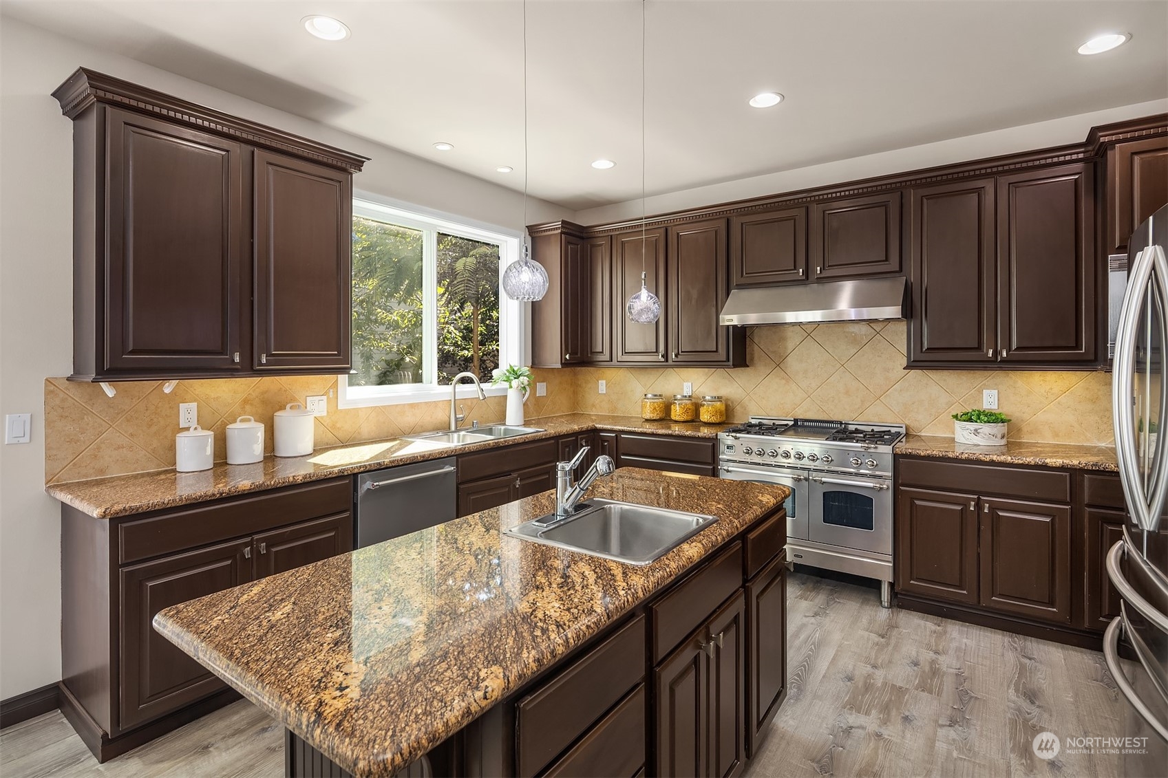 21104 39th Avenue Southeast Bothell, WA 98021 - Photo 11 of 36 a kitchen with granite countertop sink stove and cabinets