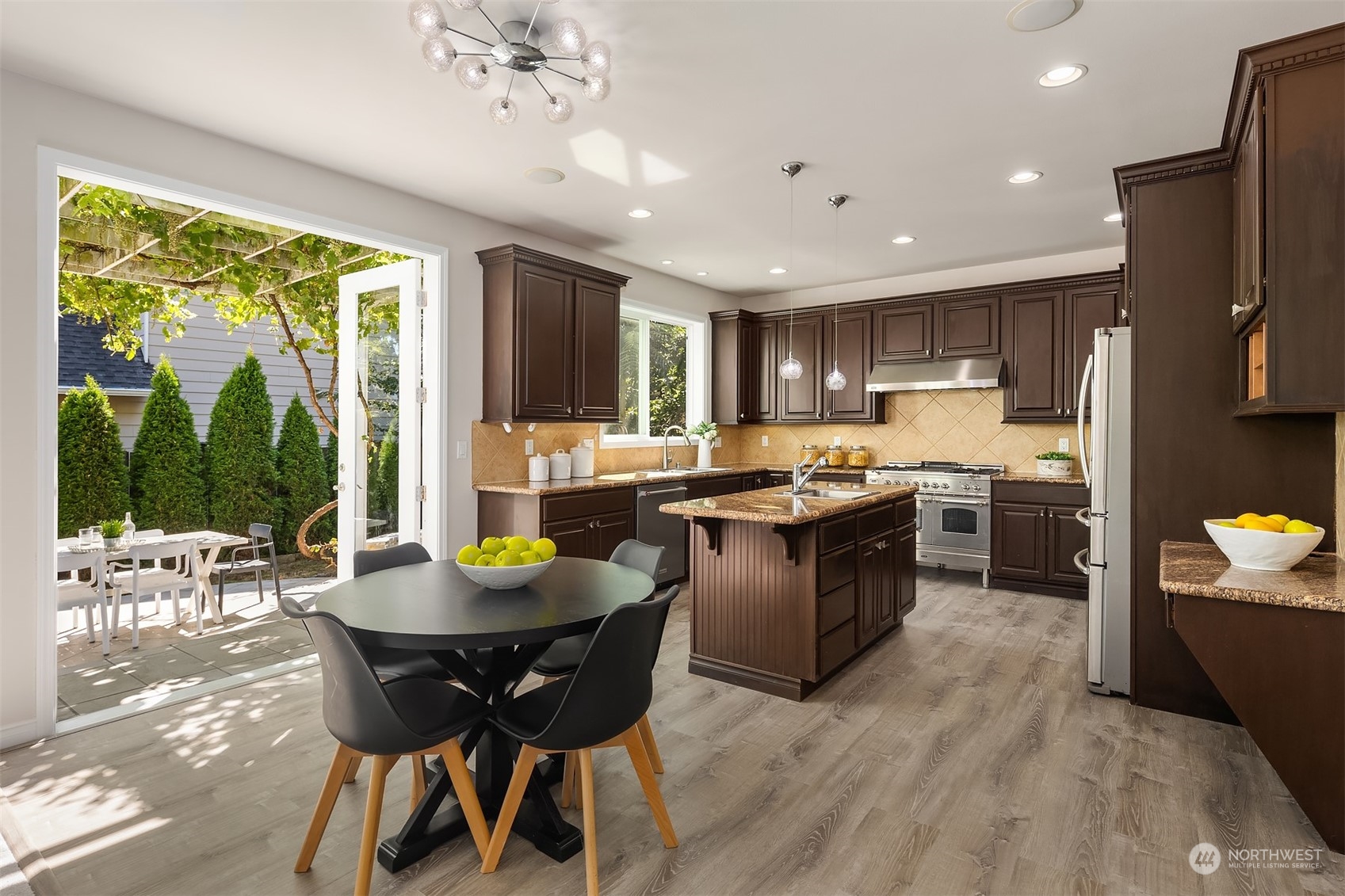 21104 39th Avenue Southeast Bothell, WA 98021 - Photo 15 of 36 a kitchen with a table chairs refrigerator and microwave