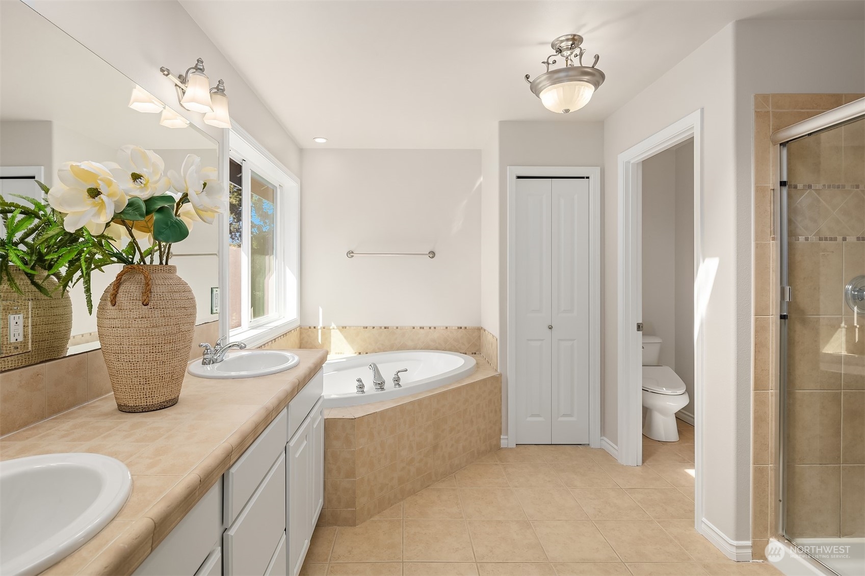 21104 39th Avenue Southeast Bothell, WA 98021 - Photo 24 of 36 a spacious bathroom with a granite countertop sink a toilet a mirror and shower