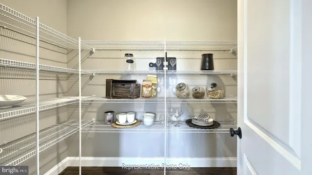 a kitchen with a refrigerator and wooden floor