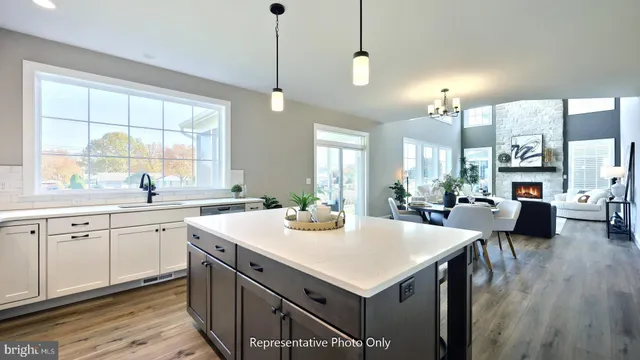 a kitchen with sink cabinets and wooden floor