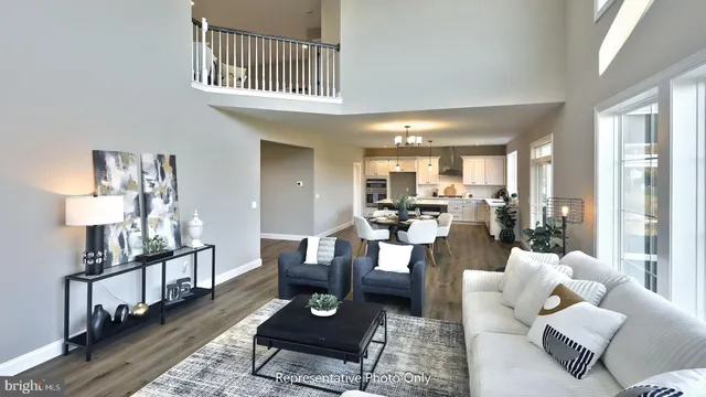 a living room with furniture couches and a dining table with wooden floor