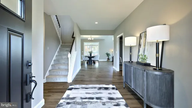 a view of a hallway view with living room and wooden floor