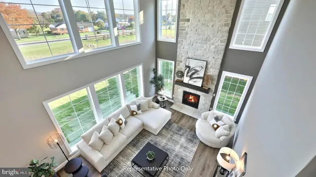 a living room with furniture and a floor to ceiling window