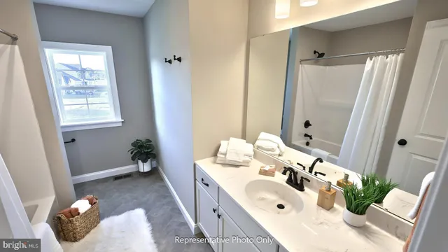a bathroom with a tub sink and mirror