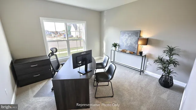a view of a livingroom with furniture and a window
