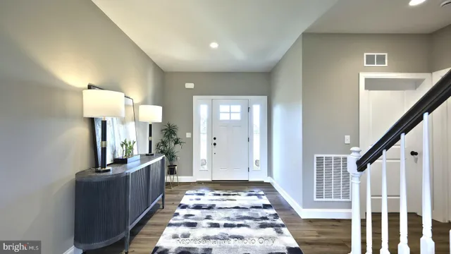 a view of a hallway with workspace and wooden floor