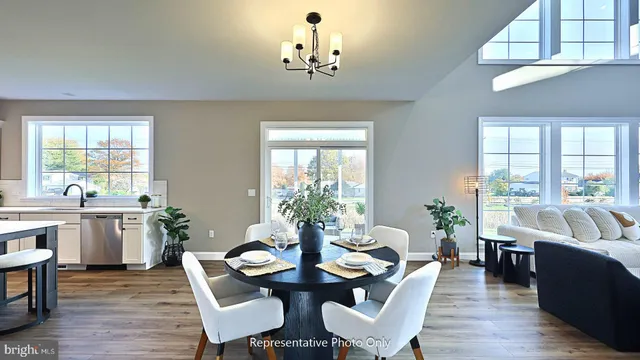 a view of a dining room with furniture window and wooden floor