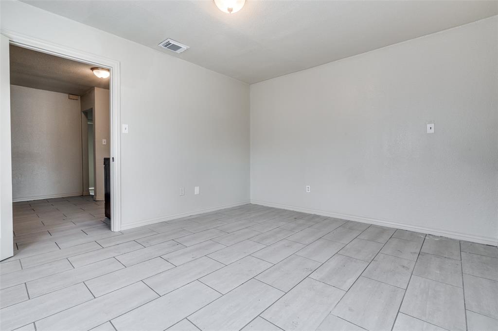 7909 Wanebe Drive Dallas, TX 75235 - Photo 6 of 25 Spare room featuring baseboards