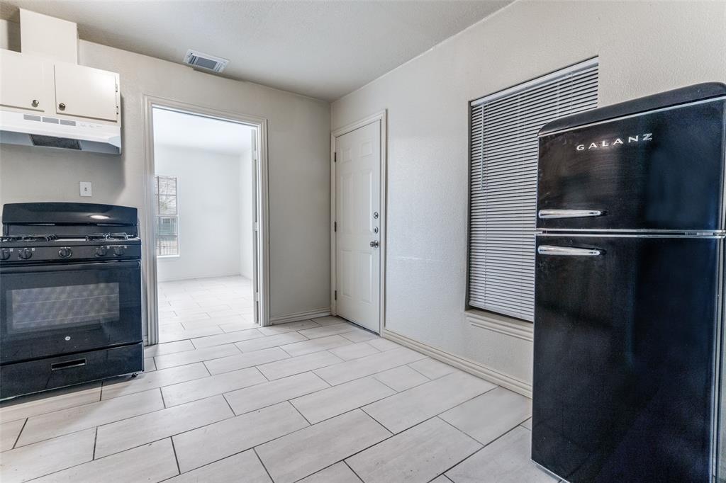 7909 Wanebe Drive Dallas, TX 75235 - Photo 8 of 25 Kitchen featuring black appliances and under cabinet range hood