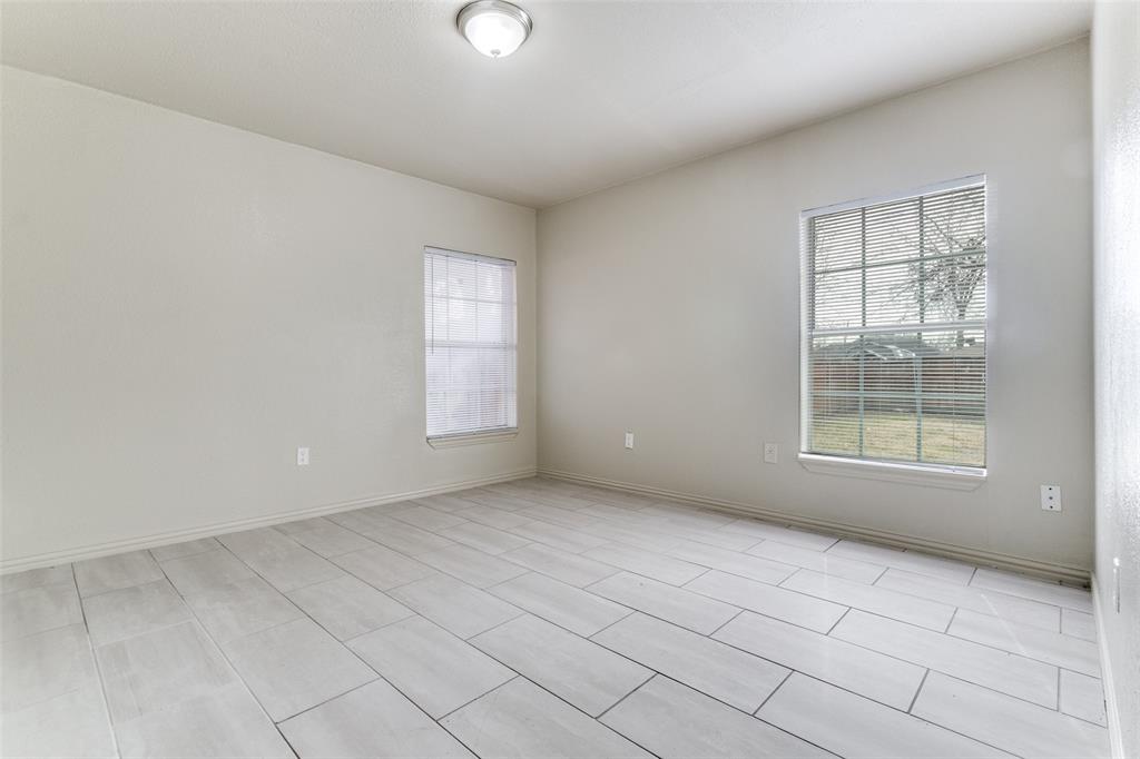 7909 Wanebe Drive Dallas, TX 75235 - Photo 9 of 25 Spare room featuring baseboards