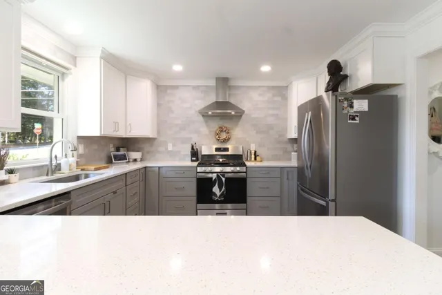 a kitchen with stainless steel appliances granite countertop a refrigerator and a sink