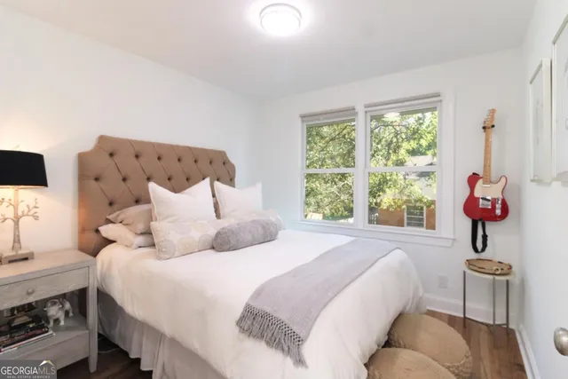 a bedroom with a bed and glass window