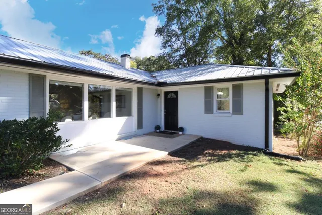 a front view of a house with a yard outdoor space and garden