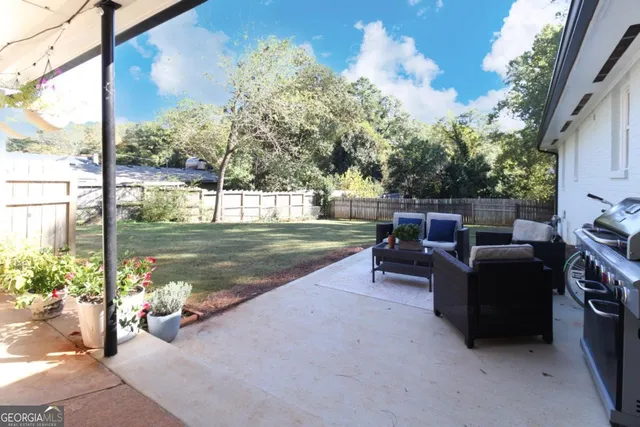 a backyard of a house with outdoor seating